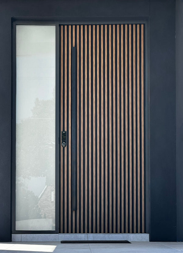 Matt black 1500mm entry door pull handle set on a dark background, featuring a slatted timber door 