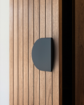 A matte black D Plate 220 Pull Handle on a vertical timber slat door