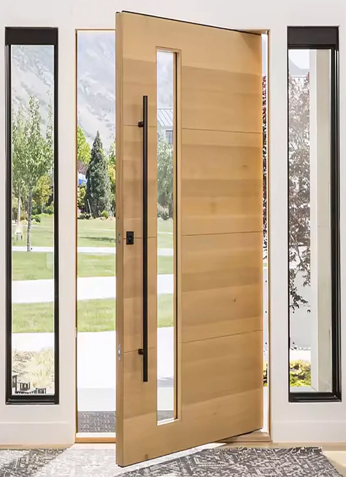 ZMTONLINE Matt black stainless steel entry door pull handle installed on a timber door with a clear glass panel (Classic Series)