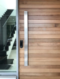 ZMTONLIONE Stainless steel entry door pull handle (urban series)  installed on a timber door.