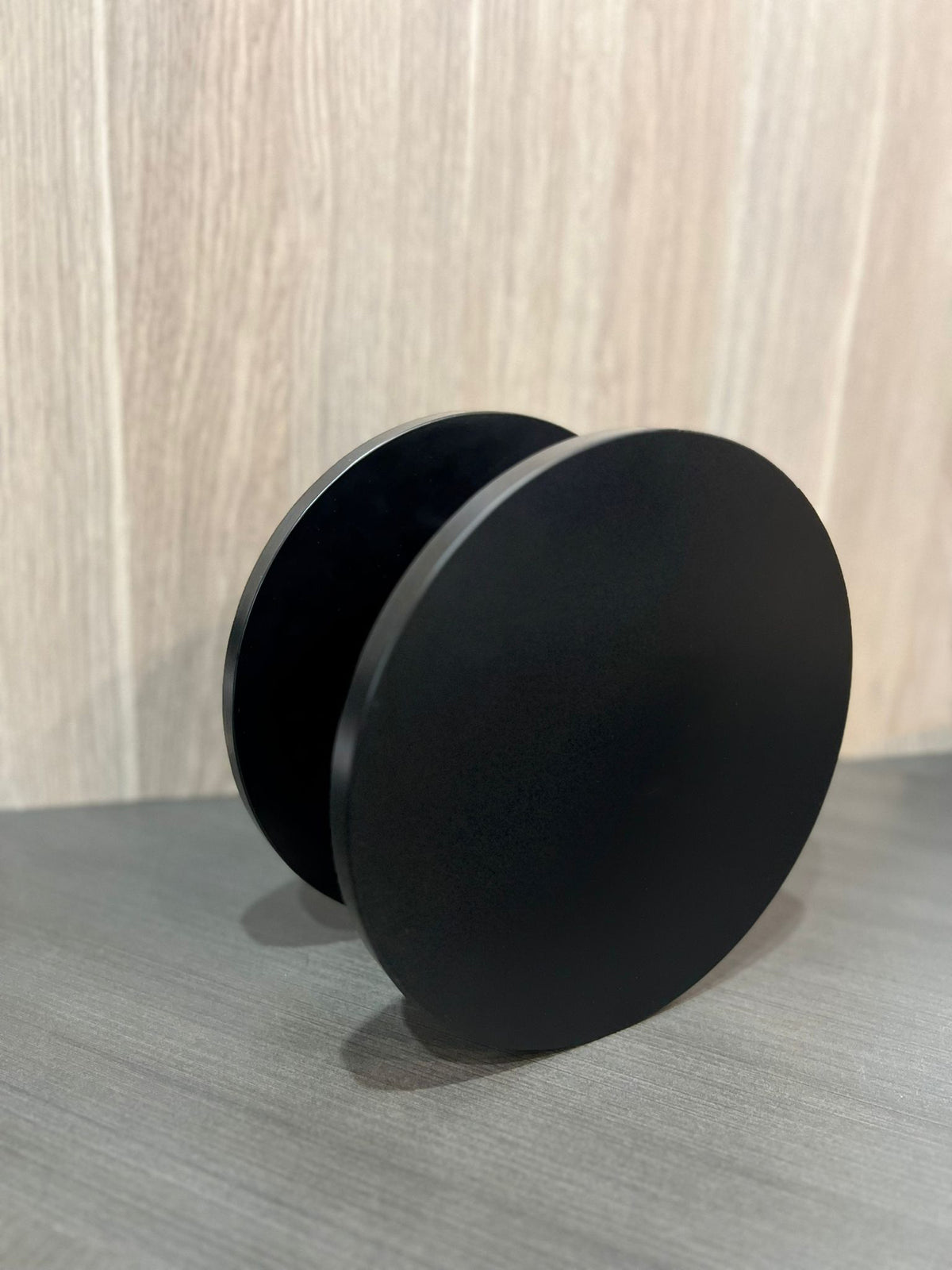 Pair of matt black round Rhondo 220 entry door pull handles viewed from the front on a diagonal